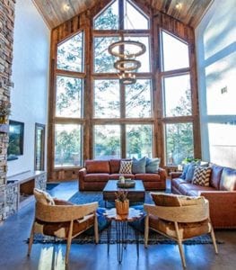 Wolf cabin living room with high ceilings and windows