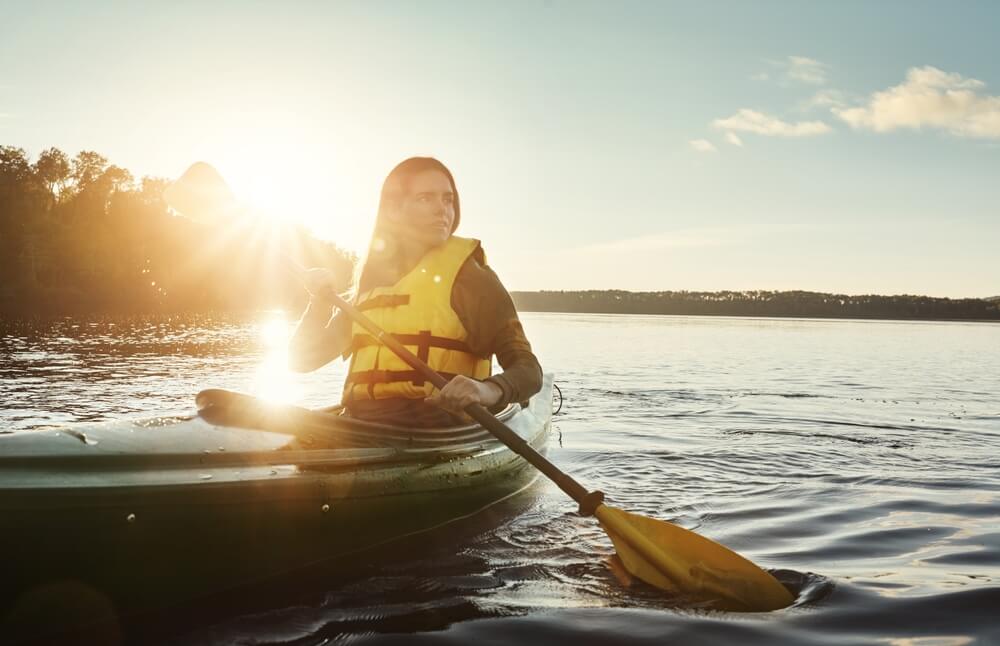 A woman kayaking on a lake in Broken Bow